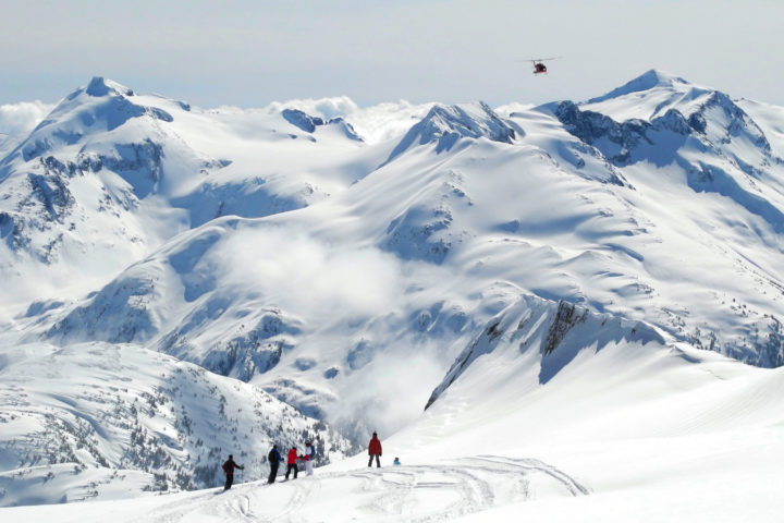 Skiers wait for their heli ride along the ridgeline.